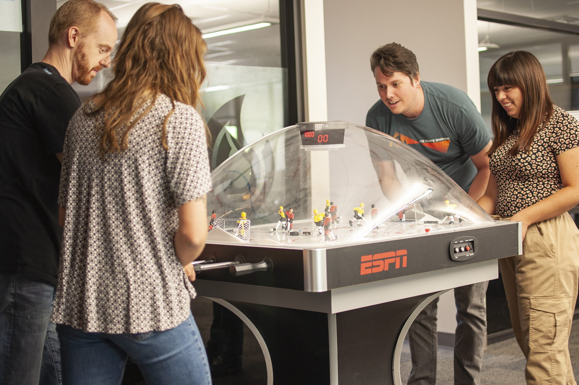 Firetoss employees playing bubble hockey