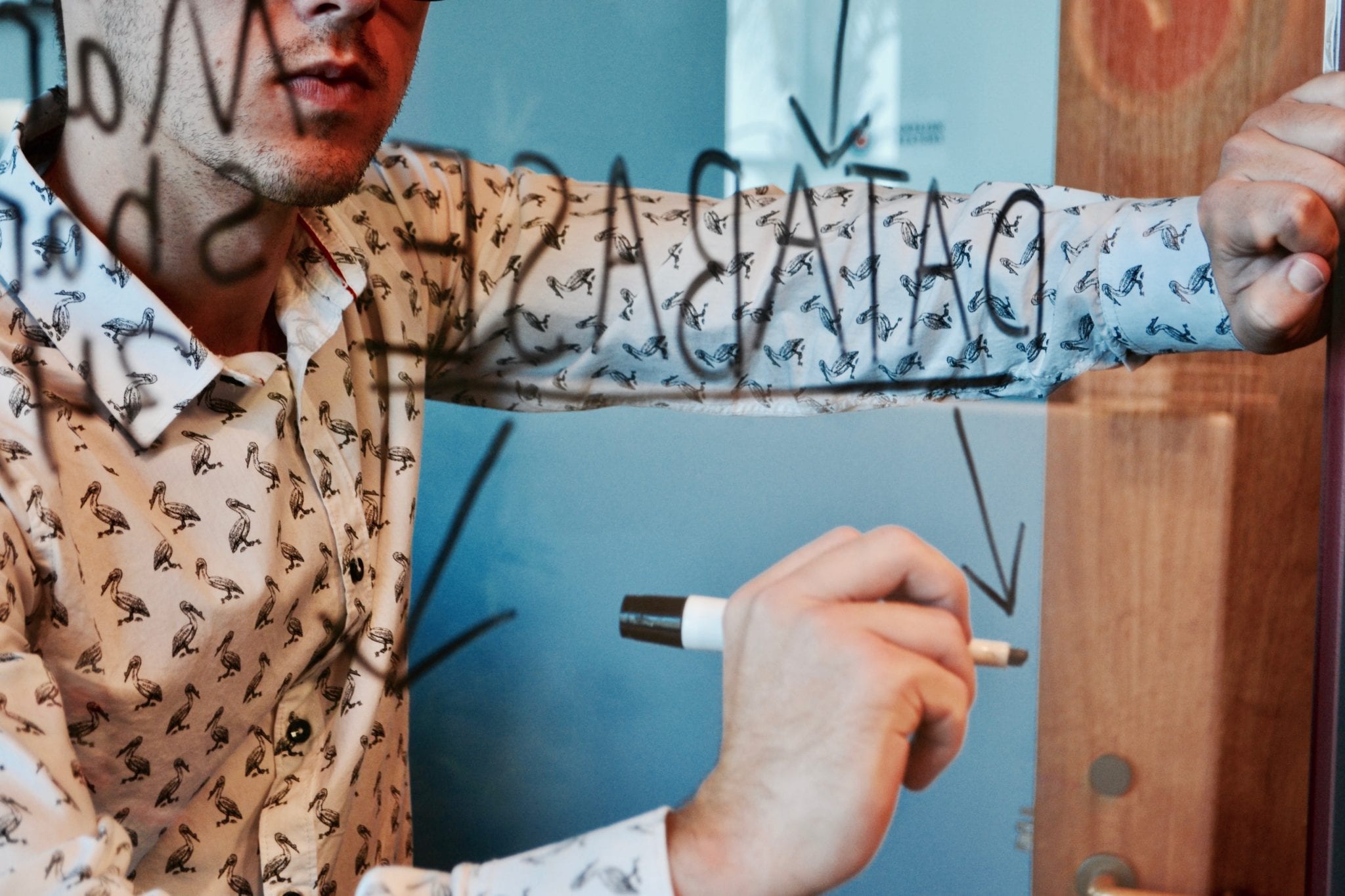 person writing on a window