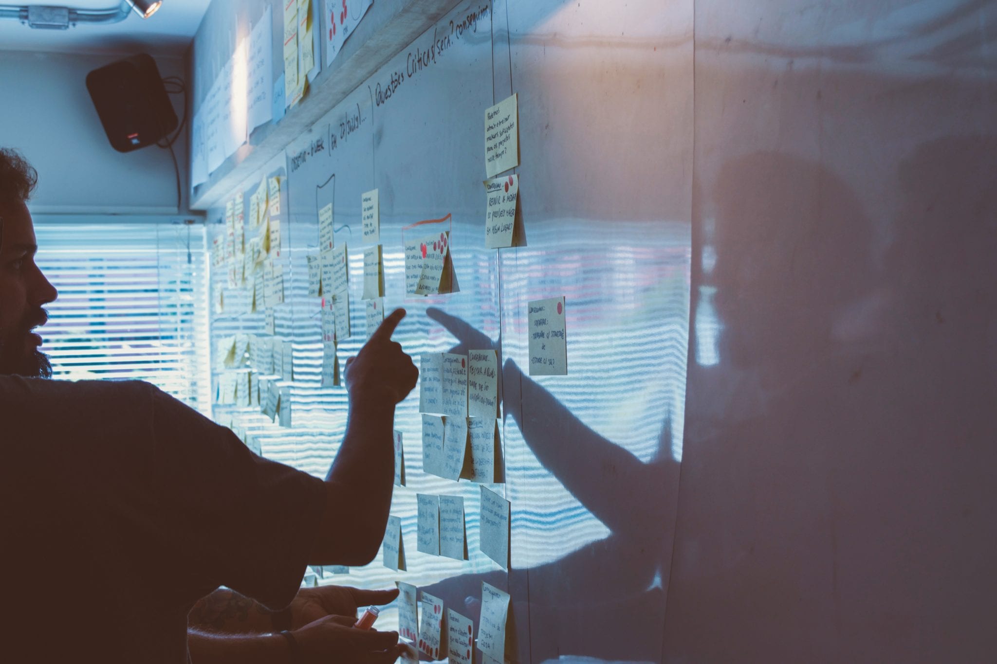 person pointing at whiteboard