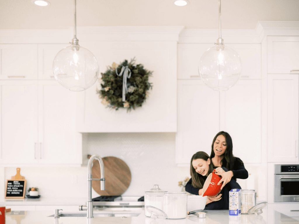 woman and child baking together in kitchen using Oatsome Oat Milk