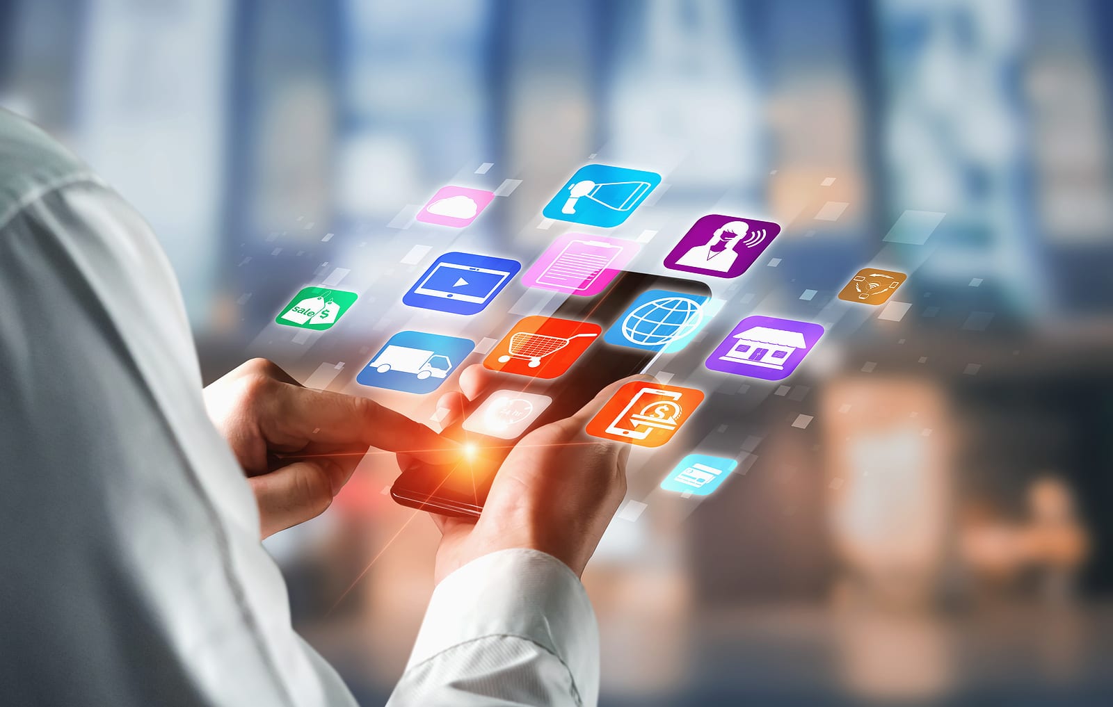 A person touches a smart phone screen and all of the apps appear in a floating manner above the phone, this conveys the evolution of technology and digital marketing