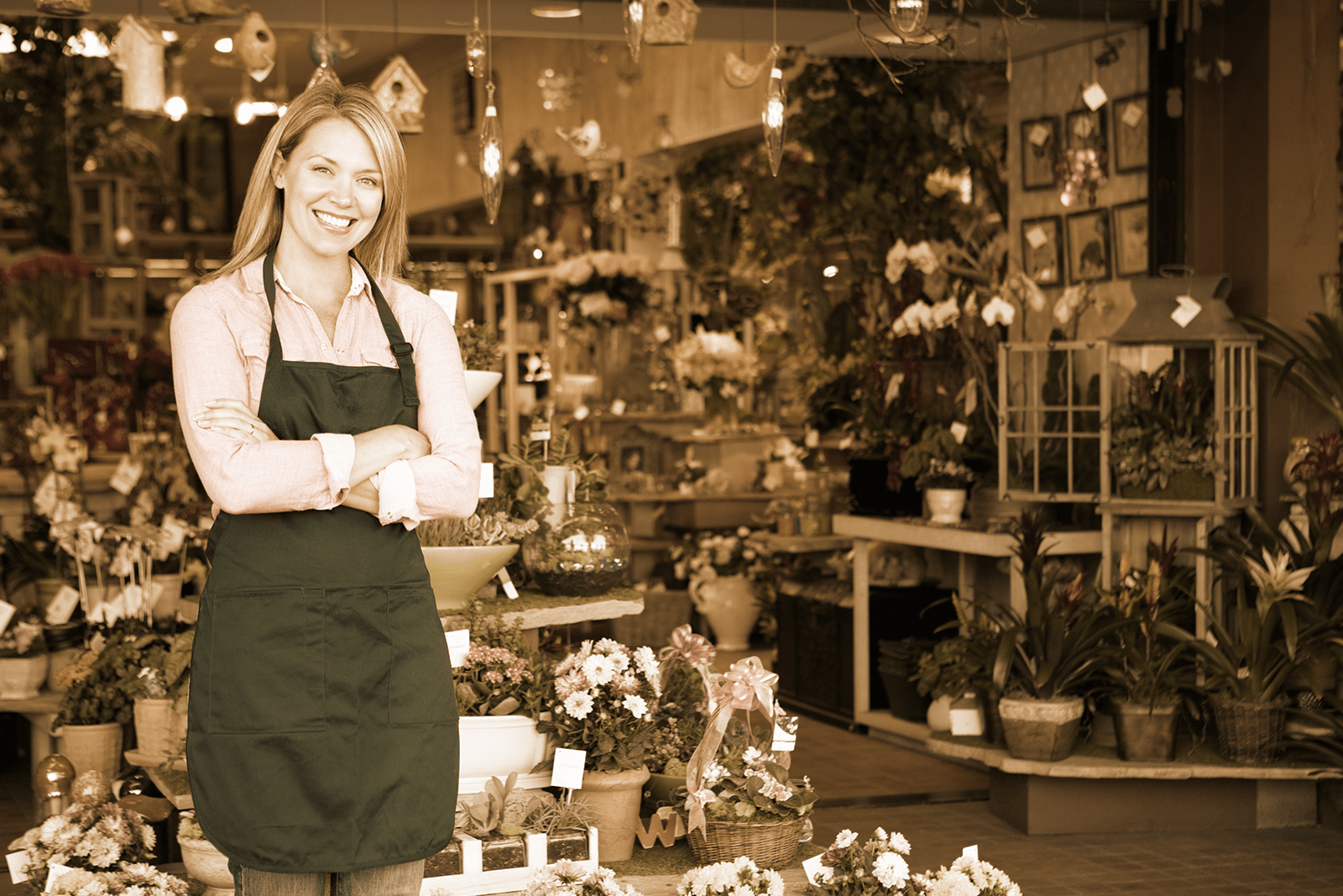 A woman stands smiling in front of her flower shop and needs local Utah SEO